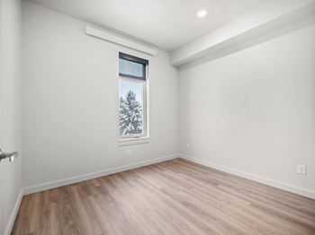 a living room with white walls and a window